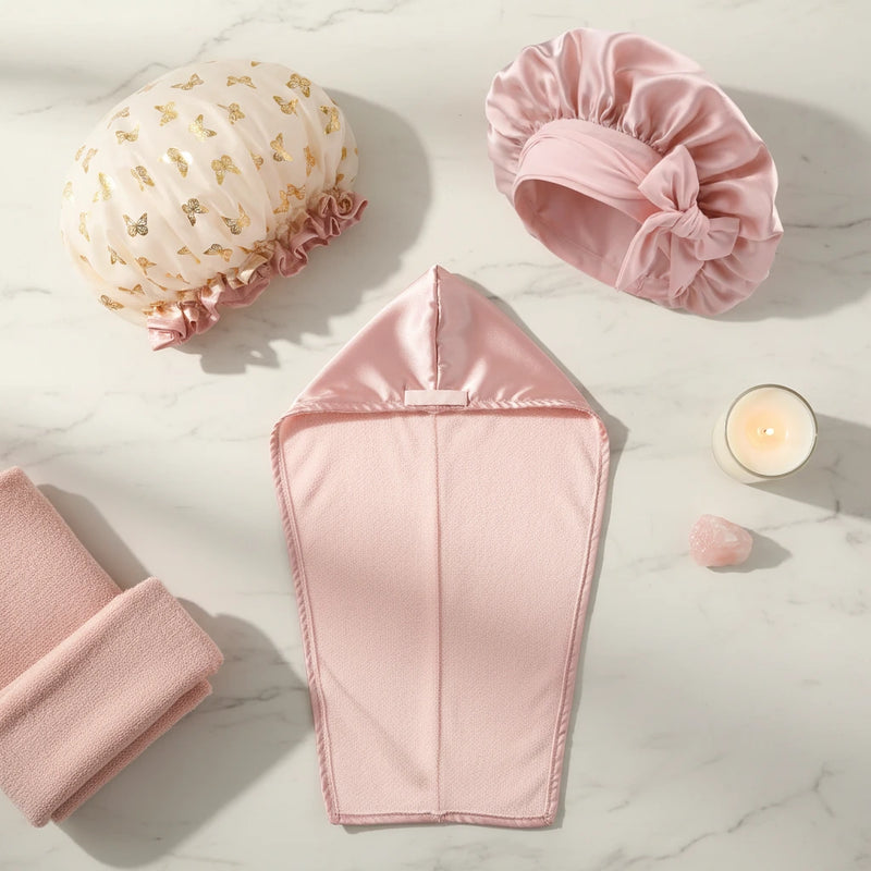 FullShine hair care bundle set featuring a waterproof shower cap, silk sleep cap, and luxury hair drying cap arranged on a marble surface.