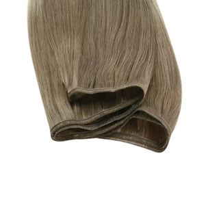Natural ombre gradient from ash brown to blonde crafted into invisible weft extensions.