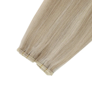 Dimensional blonde hair brightened with warm rose brown ribbons.