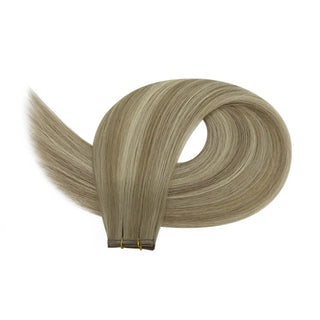 Hand-crafted extensions featuring ash brown roots and bright blonde painted highlights.