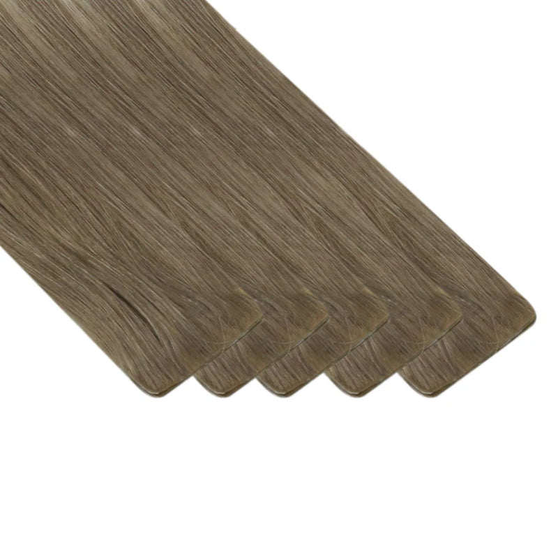 Virgin brown to blonde extensions with seamless ombre melting.