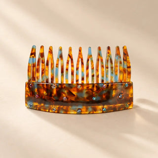 An amber tortoiseshell hair comb with colorful crystal accents inspired by the Flaming June art edition.