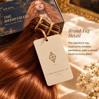A cream Full Shine brand tag with the signature diamond emblem attached to an auburn hair extension bundle inspired by The Bridesmaid.